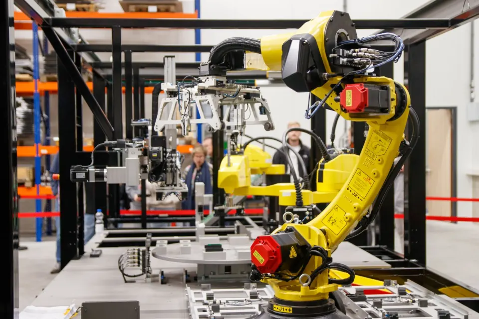 Yellow industrial robot in a production hall